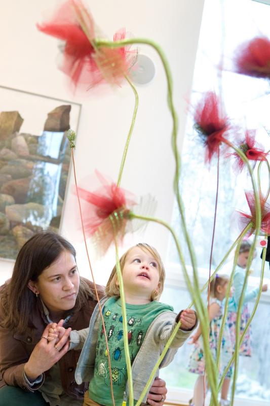 Friends Academy teacher Marlaina Trepanier and her son Henry, 2, enjoy the "Field of Poppies" display. BY DOLLY GENANNT